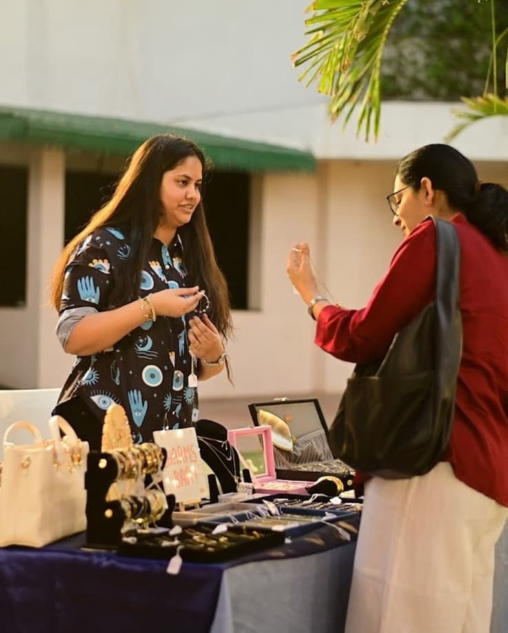 Muskaan at a market stall with the funky trunk jewellery on display