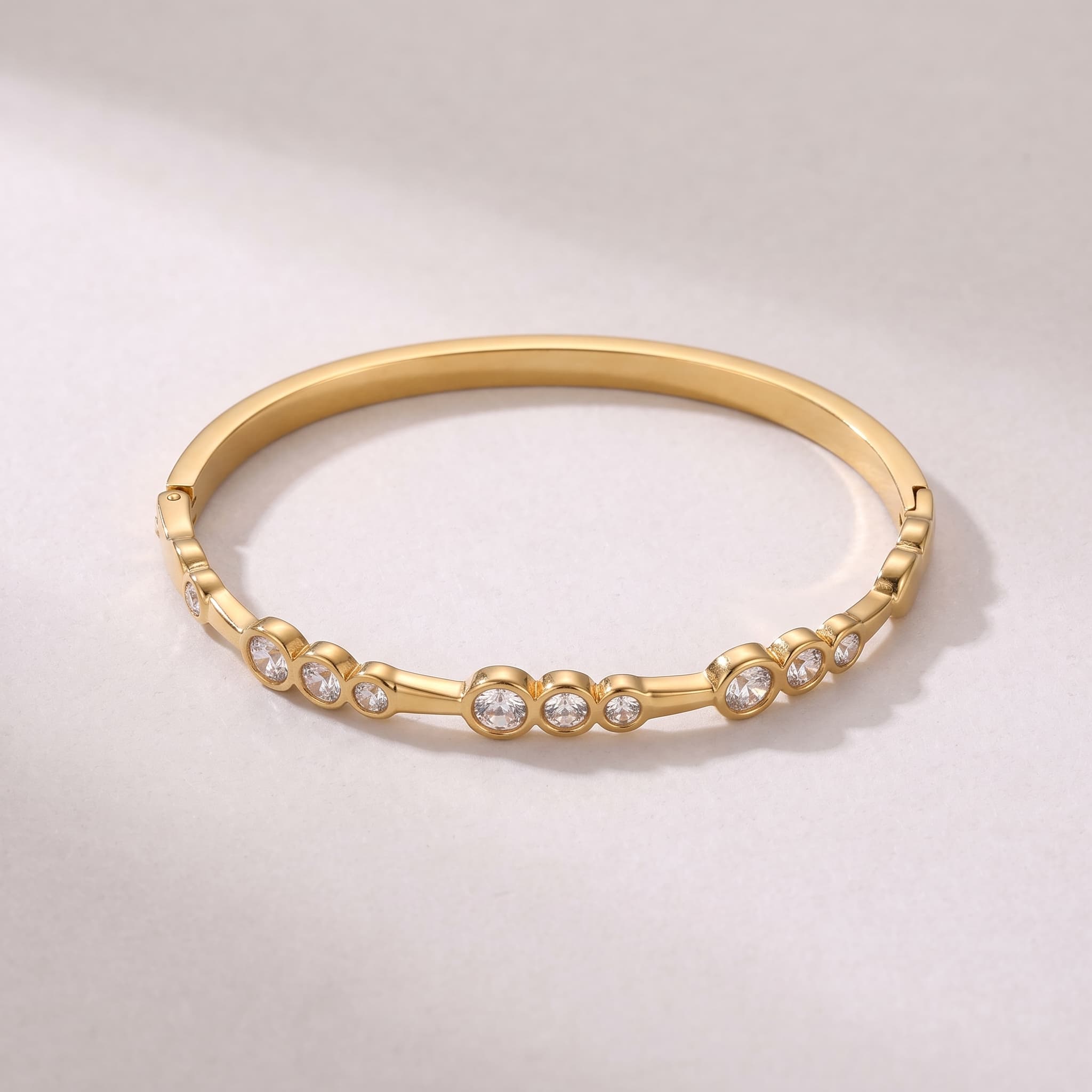 delicate stone studded gold bangle