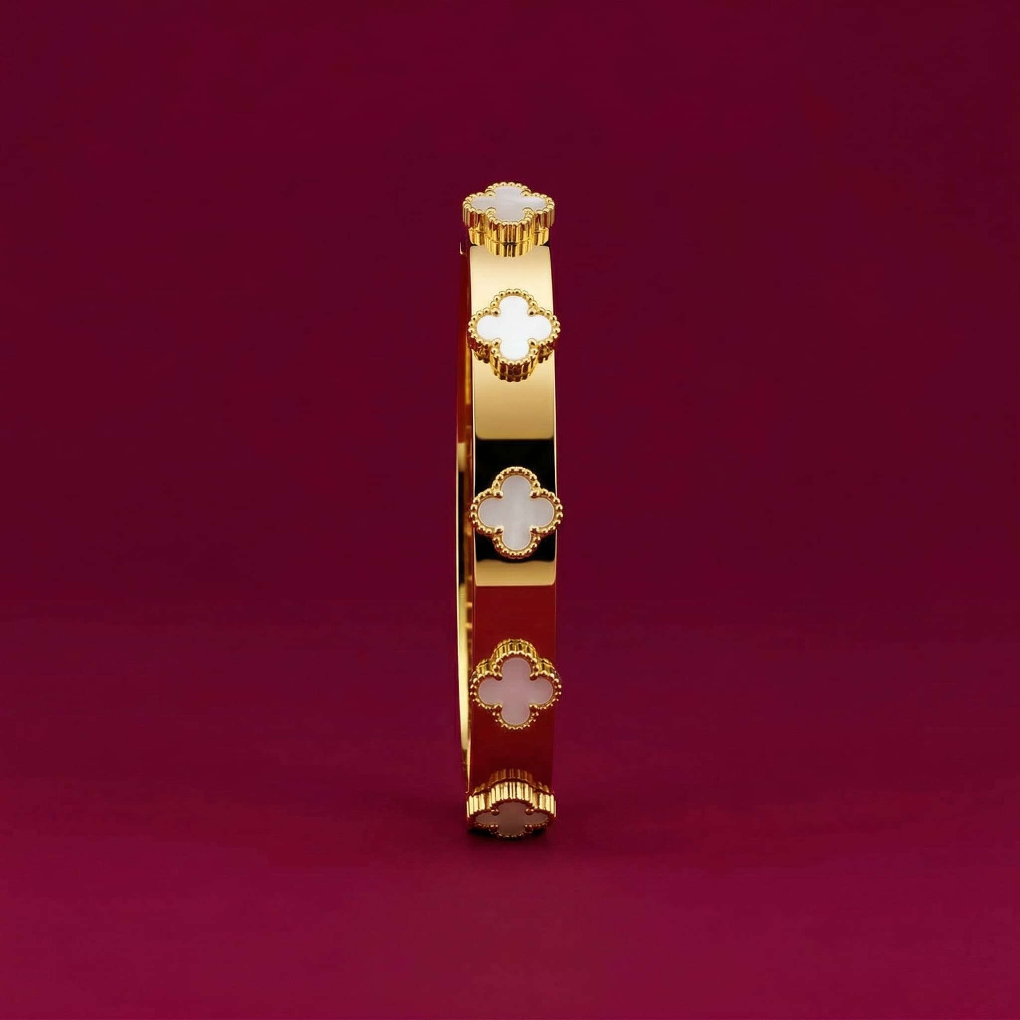 clover motif gold bangle