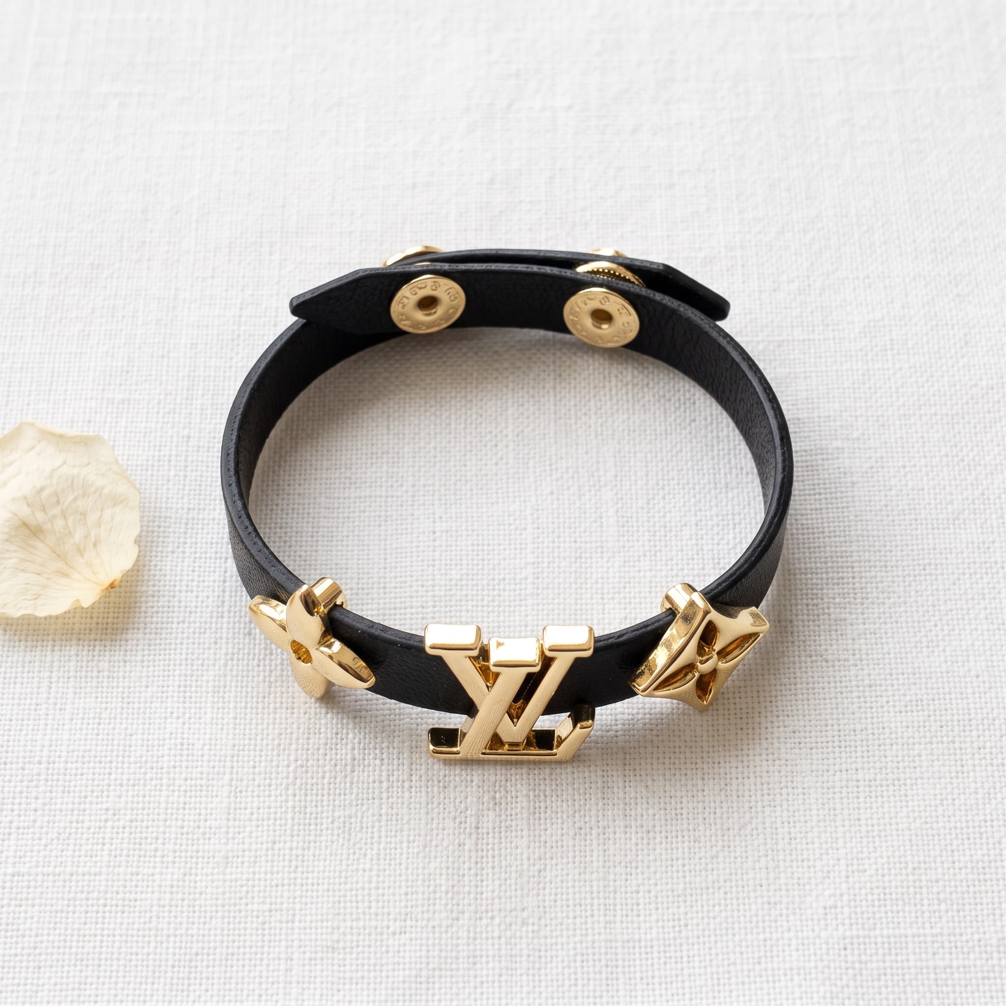 black and gold logo bracelet