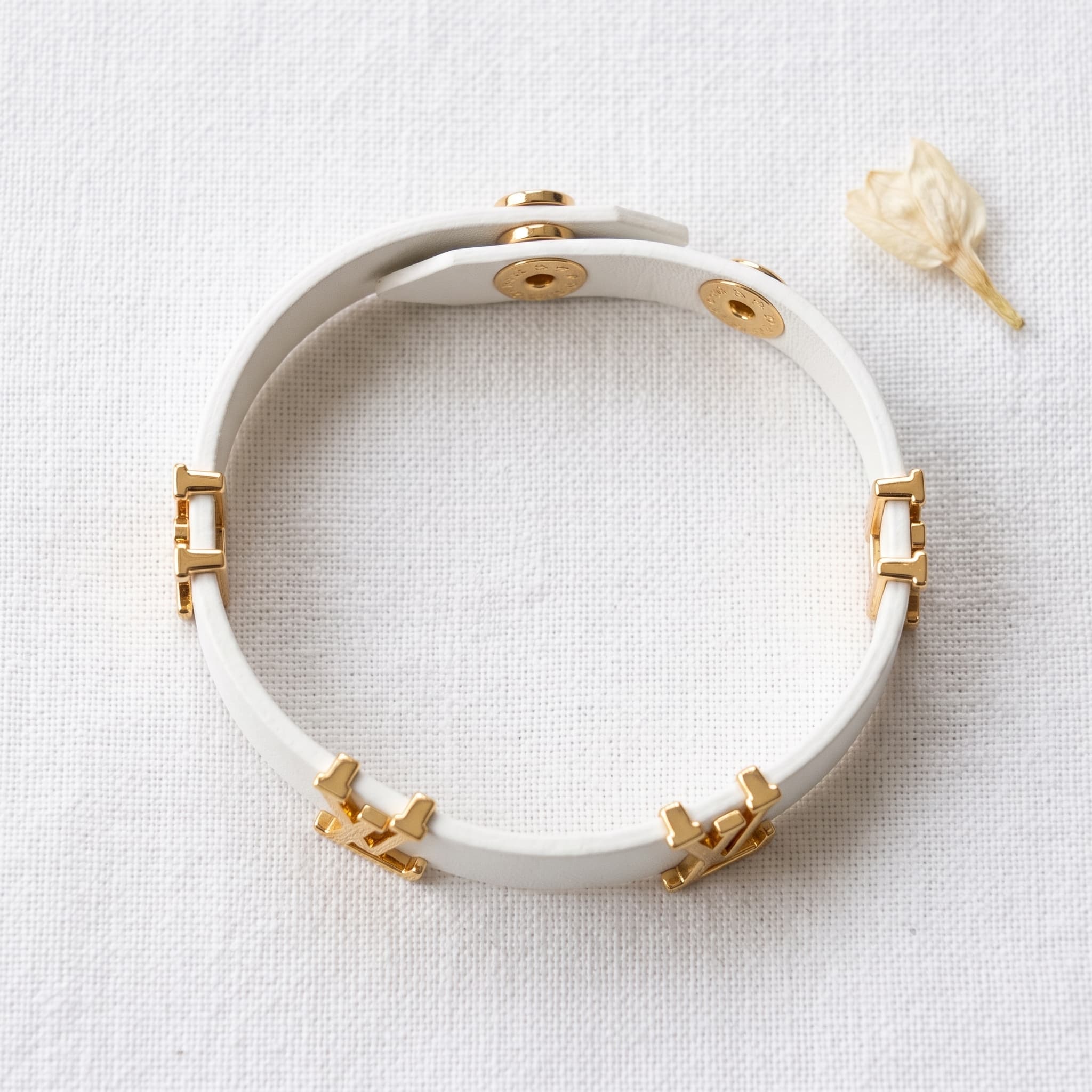 white leather and gold bracelet