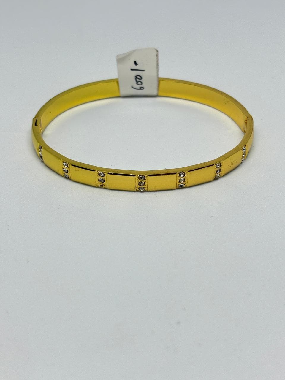 sleek stone-studded gold bangle